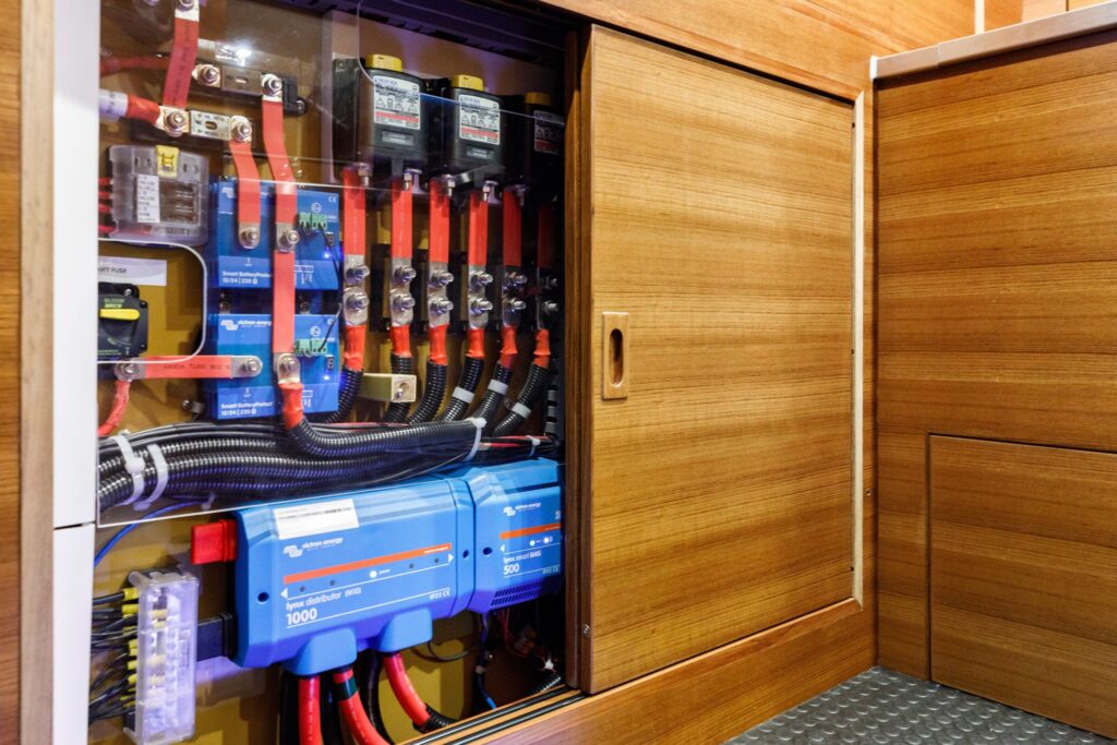 Advanced electrical control panel inside custom yacht cabinetry
